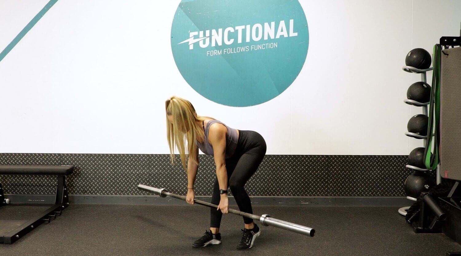 Woman leaning forward with a barbell