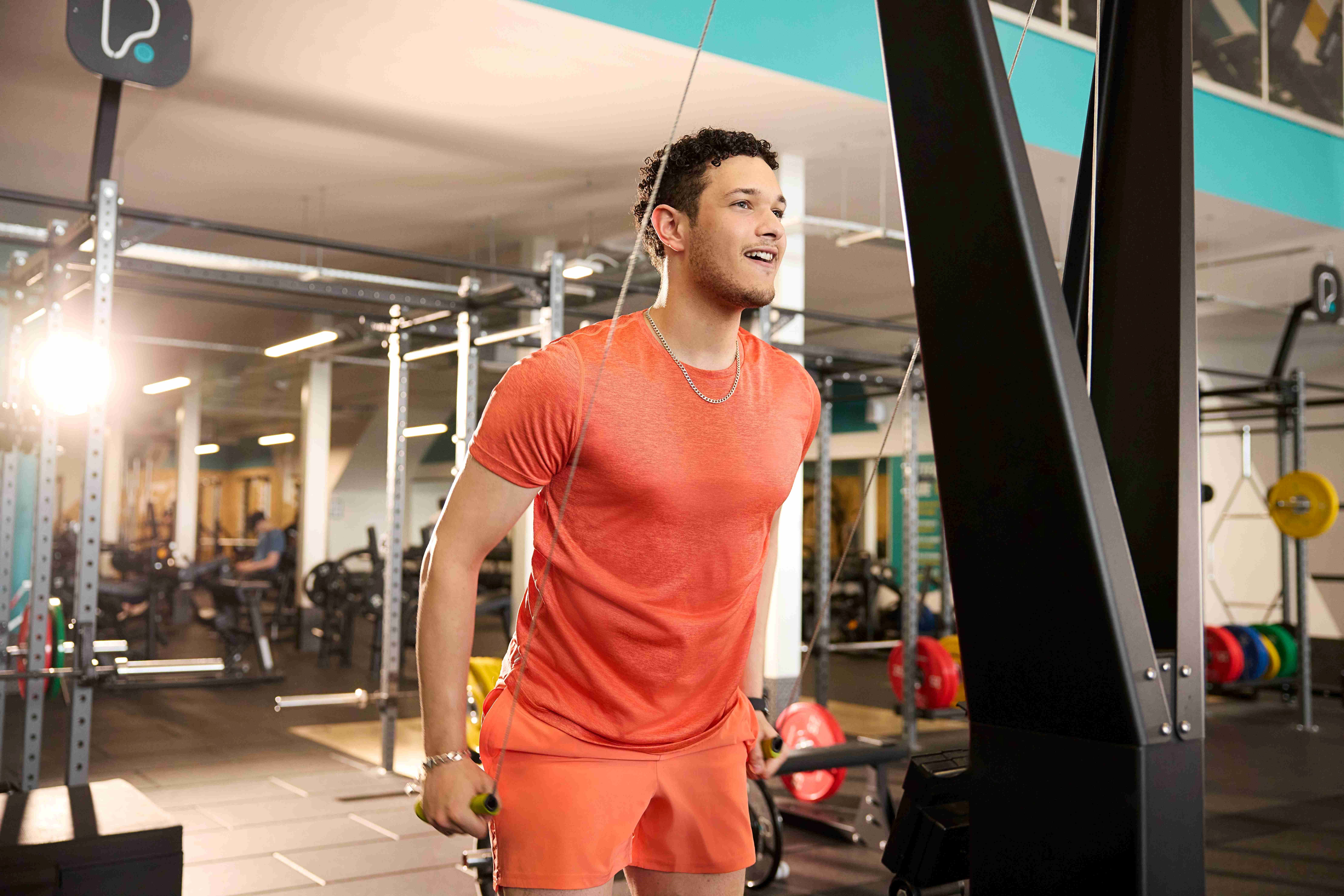 PureGym members using a cable machine