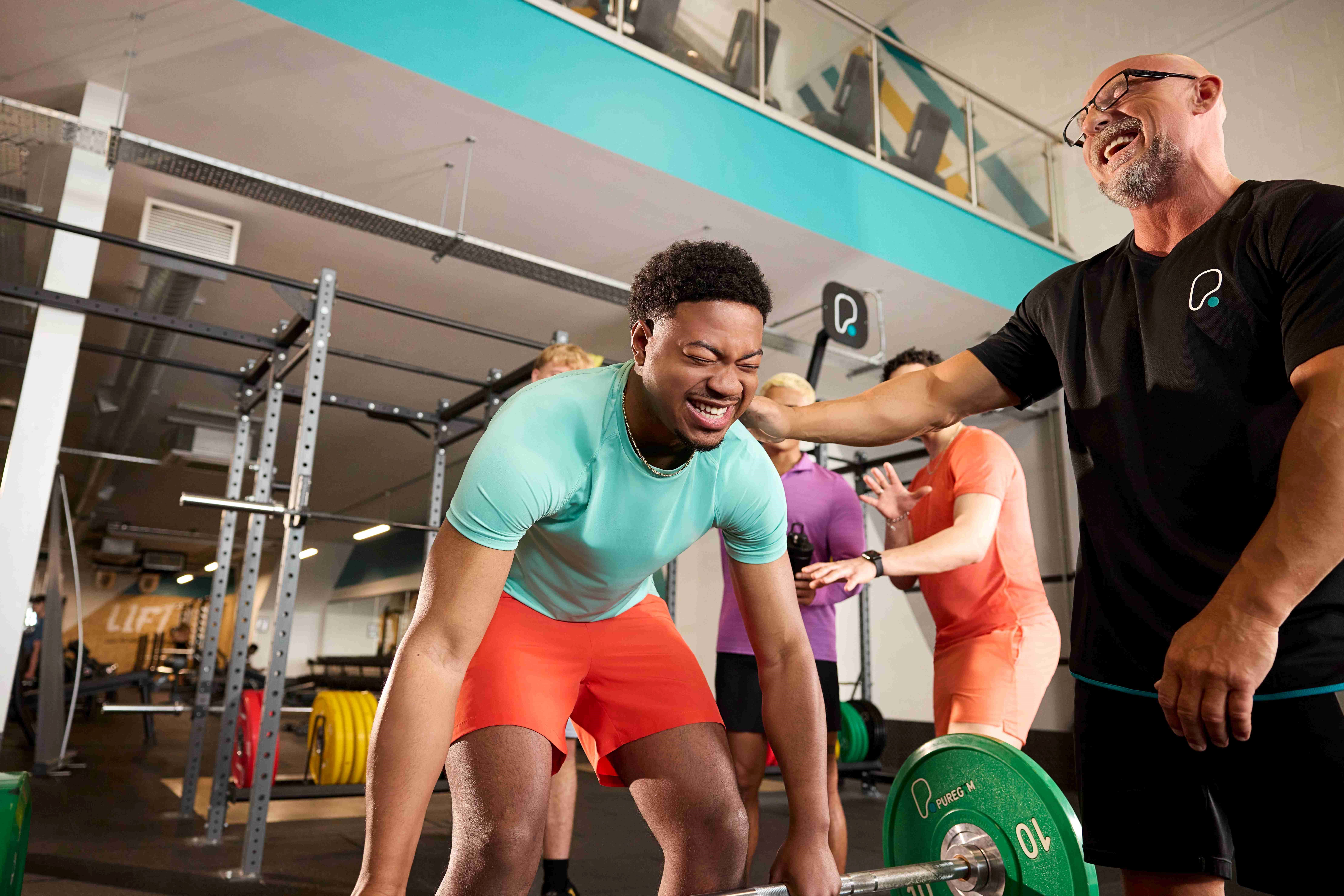 Two people performing sandbag lunges